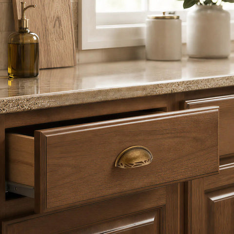 Three Pack Antique Brass Half Moon Cup Pulls For Kitchen Cabinets And Drawers Featuring Hella Smooth Finishes And Rock Solid Zinc Alloy Build With Detailed Cuts That Bring Fresh Charm To Furniture And Vanity Projects Quick And Easy on a wooden drawer.