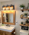 Rustic Three Light Vanity Fixture With Industrial Black Finish And Faux Wood Back Panel in bathroom setting
