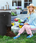 34 Gallon Outdoor Compost Bin With Handles And Observation Windows, Thickened Breathable Foldable Design For Easy Garden Yard Recycling, Home Compost Bucket, No Mess And Durable Black 1 Pack with a gardener preparing plants in the background.