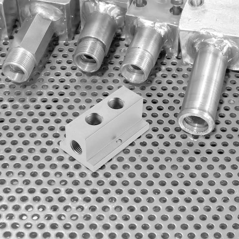T-Type Pneumatic Air Distribution Block 2-Position 4-Port Compact Gas Manifold on perforated metal surface