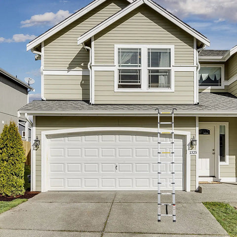 12.5 Foot Aluminum Telescoping Ladder With Non Slip Feet And Stable Hook Portable Extension Ladder leaning against garage