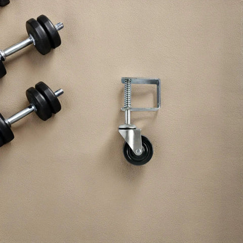 Heavy Gauge Four Inch Gate Roller Caster Wheel Featuring Flexible Spring Bracket System For Rock Solid Stability And Smooth Gliding Action On Rough Ground on a beige surface.