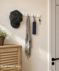 Heavy Duty Wall Mount Coat Rack Featuring Five Lock Down Hooks For All Your Everyday Essentials Like Hats Keys Wallets And Bath Towels Crafted From Corrosion Proof Aluminum In Crisp White Two Pack Bundle with hat, scarf, and keys.
