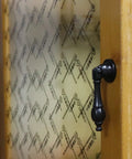 Badass Vintage Black Tear Drop Cabinet Knobs 5 Pack on wooden cupboard with printed backing, premium zinc alloy material.