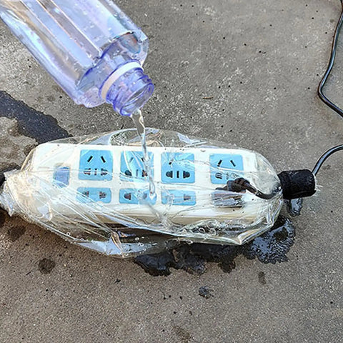 No Sweat EV Charger Cover For Your Ride Rock Solid Waterproof Housing protecting an electric outlet from pouring water.