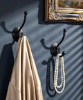 Heavy Duty Black Wall Mounted Coat Hooks 10 Pack With Complete Hardware Kit No Fuss Setup, displaying a coat and pearls.