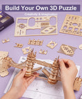Person assembling Tower Bridge 3D Puzzle Wood Craft Kit with LED Light DIY Construction Model, parts laid out on table.