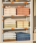 3 Pack Expandable Metal Closet Organizer Shelves with stacked clothes, adjustable and white, ideal for wardrobe and pantry storage.