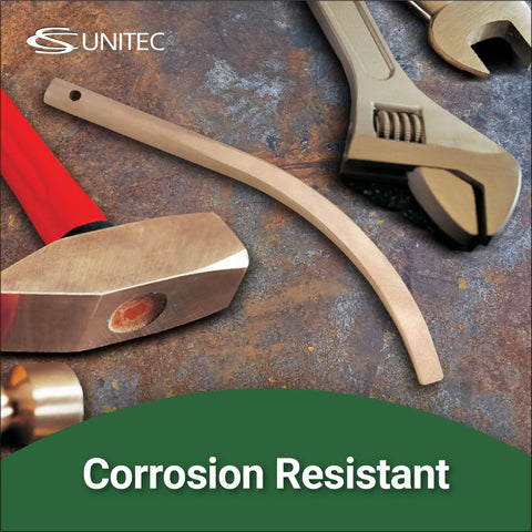 Non Sparking Copper Beryllium Banana Wedge With Lanyard Hole Three Quarters Inch Wide 12 Inch Long Non Magnetic Corrosion Resistant ISO 9001 2025 Certified Rugged Worksite Ready For ATEX EX Zone And Petrochemical Plants surrounded by tools on metal surface