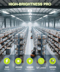Warehouse lit by 4 Pack 300W LED Linear High Bay Shop Lights With Motion Sensor, showing bright central lighting, 45000 Lumens, 5000K Daylight