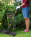 Person holding Heavy Duty Lawn Leveling Rake With 30 Inch Blade And Adjustable Handle For Easy Yard Dirt Grading