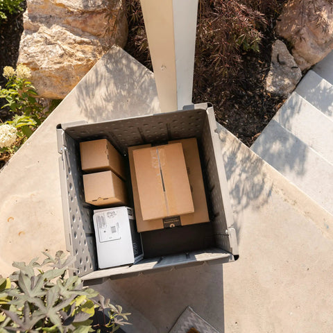 Versatile Outdoor Storage Cube Deck Box Doubles As Cozy Bench Seat And 25 Gallon Capacity Weather Resistant Patio Organizer with packages inside.