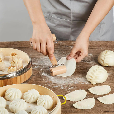 Real Deal 10 Inch Bamboo Steamer Basket Set With Dome Lid Stainless Steel Ring Adapter Dough Roller Press Tools For No Sweat Homemade Dim Sum Buns with rolling dough and dumplings.