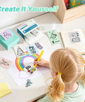 Portable Mini Sticker Printer With Three Thermal Rolls Compact Wireless Label Maker For Teachers And Craft Crews at a colorful crafting table.