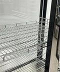 Top Shelf Commercial Four Door Glass Display Cooler Packing Hella Storage With Six Hundred Liters Smart Digital Temp Tracker Two Hinged Doors Bright LED lighting and Dead Solid Chrome Shelves Ready To Stock Your Store Quick showing chrome shelves inside.