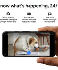Person holding phone displaying live feed from Indoor Nest Security Camera 1080p Wired 2nd Generation Snow Color With Smart Motion Detection