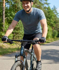 Cyclist riding with 21 Speed Twist Shifter Set With Left And Right Revoshift Grips For Mountain And Hybrid Bikes on a forest trail