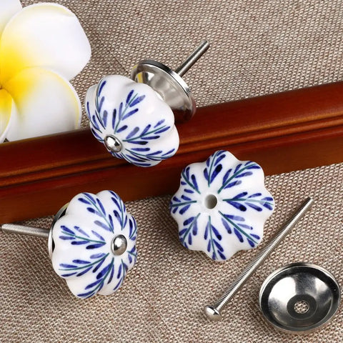 Snag These Six Piece Vintage Shabby Ceramic Cabinet Knobs With Hand Painted White And Blue Floral Drawer Pulls For Cupboard And Dresser Hardware To Level Up Your Home Decor Game Today, featuring round ceramic knobs with floral designs.