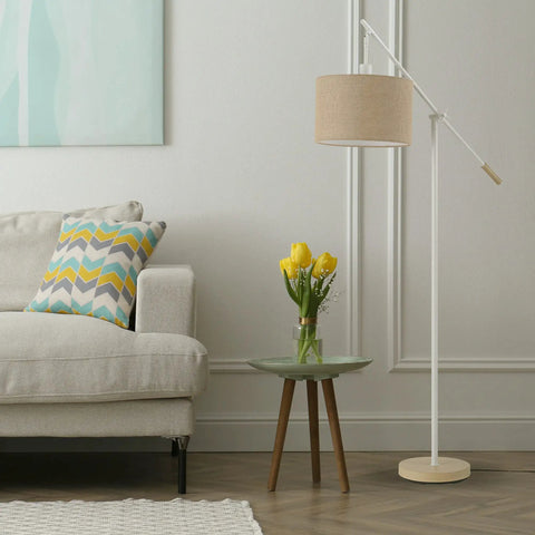 Serena 66 Inch Floor Lamp with matte white finish, faux wood accents, natural jute shade next to a modern sofa and table.