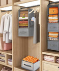 Big Time Hanging Closet Organizer With One Easy Fold Drawer And Three Roomy Shelves For No Sweat Closet Organization And Rock Solid Rod Mount Storage In Classic Grey inside a wooden closet with clothes.