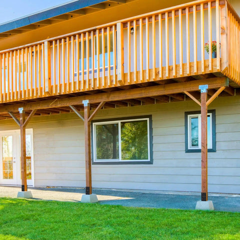 Installed Heavy Duty U Shaped Fence Post Anchor Ground Spike 4 x 4 In Concrete Base for Fence Railing and Pergola Posts on wooden deck