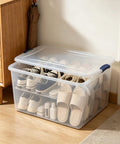 Ginormous 105 Quart Clear Storage Bin With Blue Secure Latch heavy duty plastic tote storing various shoes and slippers.
