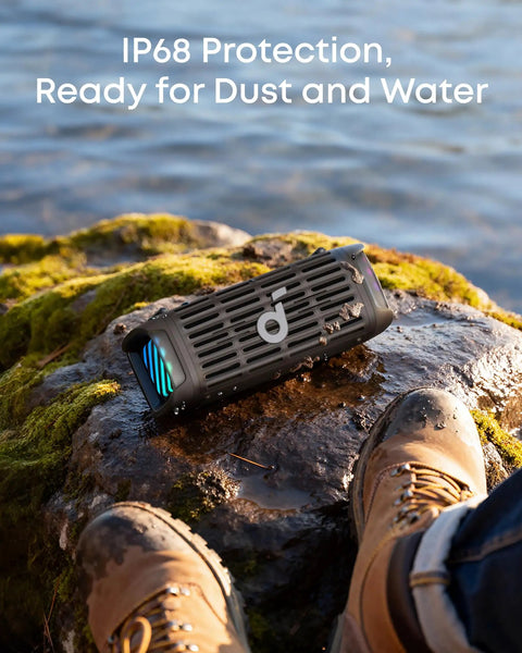 Compact Outdoor Speaker With Floating Playback Stays Upright In Waves IP68 Waterproof Saltwater Resistant on rock by water