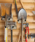 Real Deal Steel Shovel Holder Wall Mount 2 Pack With Extended Tines holding shovels and tools on a wooden wall.