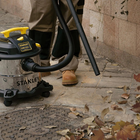 Person using Beast Of A 5 Gallon Wet Dry Shop Vacuum with 4 Peak HP Motor Stainless Steel Tank Portable Vac outdoors