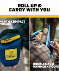 Portable Camping Hammock With Tree Straps Up To 400 Lbs Built For Outdoor Adventures Easy Setup In Seconds in compact storage bag next to seated person using hammock pocket