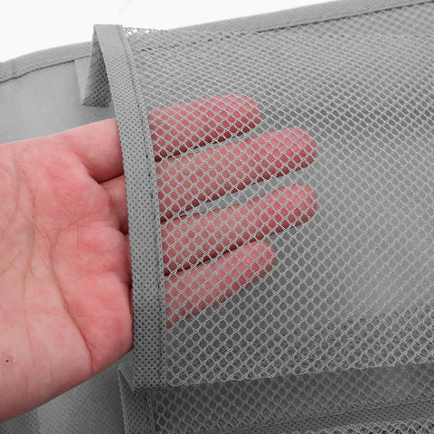 Hand showcasing the mesh pocket detail of the Slick Door Shoe Organizer With Six Deep Mesh Pockets And Heavy Duty Hanging Hooks.