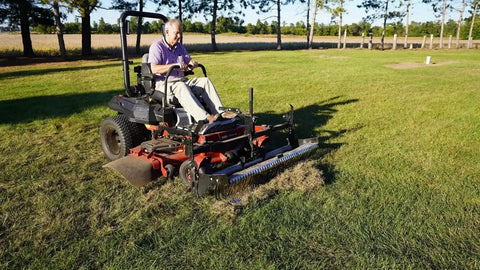 Zero Turn Mower Rake Attachment For Leaves Walnuts Gravel Acorns Grass And More Swinging Toolbar Rake Mounts On Your Black Zero Turn Mower Beefy Yard Cleanup Tool That Makes Debris Pickup A Breeze installed on a mower, raking lawn