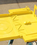 Universal Ladder Tray Rack Fits Extension And Step Ladders Heavy Duty Mid Section Tool Shelf Holds Twenty Pounds Quick Clamp Setup view from above, bright yellow durable plastic surface.