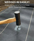 Hammer installing Flip Washer Garden Stakes And Landscape Staples, 6 Inch Metal Yard Spikes for backyard landscaping on fabric