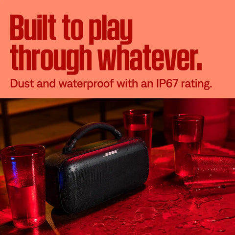 SoundLink Max Bluetooth Speaker Portable Party Ready With Deep Bass And Big Sound IP67 Waterproof Rope Handle Up To 20 Hours Of Playback USB C Connectivity And Built In 3 Point 5mm Aux Input on a table with water droplets