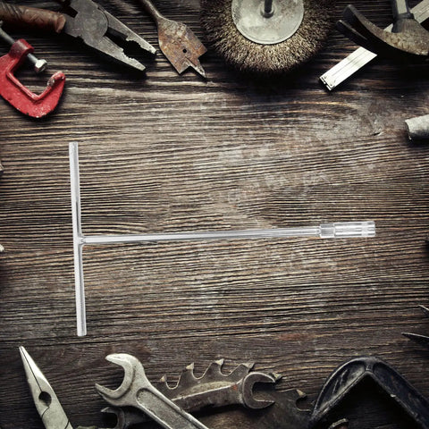 Heavy Duty T Shaped Socket Wrench 10Mm Hex Bit Driver laying on a wooden surface surrounded by various tools.