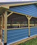 A blue carport supported by 6x6 wood posts with 4 Pack Bolt Down Square Fence Post Brackets for stability and durability.