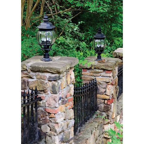 Stone wall with mounted black lanterns in garden setting, illustrating use for Post Adapter For Surface Mounting Round Posts With Included Anchor Bolts And Set Screws Black Aluminum Flange Base No Brainer Install For Deck Railings Lighting Or Fence Posts.