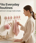 Game Changer Adhesive Corner Hooks With Smooth 180 Degree Rotation Foldable Rack on bathroom wall holding towels and loofahs.