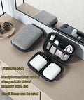 Road Ready Hard Shell Tech Organizer Case With Water Repellent Coating And Shock Absorbing Build designed for packing cables and chargers on a table.