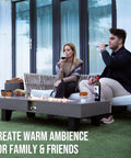 Outdoor setup with a 54 Inch Propane Fire Pit Table With Rain Cover For Outdoor Patio Backyard Or Deck 50 000 BTU Gas Heater Rectangular Modern Wood Look Fire Pit Durable Stainless Steel Burner Bowl Effortless Setup And Use.