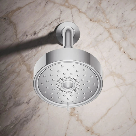 Polished chrome Purist Three Function Showerhead 2.5 Gpm with spray modes visible, mounted on marble wall