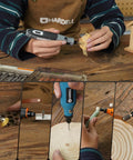 Person using Heavy Duty 508 Piece Rotary Tool Accessory Kit for detailed woodwork and crafting tasks on wooden surface.