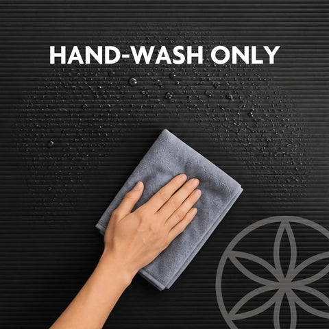 Hand washing a grey cloth on the textured surface of a Killer 10mm Thick Yoga Mat With Big Time Cushioning Plush NBR Foam.