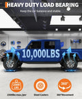 Set Of 4 Badass Car Dollies With 10000 Pounds Capacity And 3.5 Inch Solid Steel Wheels For No Sweat Hauling Cars Trucks And Boats In Rugged Black Finish under blue truck showing heavy load capacity of 10000lbs.