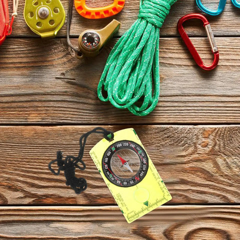 Pocket-Sized Orienteering Compass With Scale Navigation Tool for Outdoor Adventures shown on wooden table