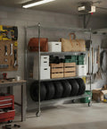 Heavy Duty 5 Tier Rolling Storage Rack With Hella Tough Steel Wire Shelves And Rock Solid Weight Rating For Zero Drama Tool Free Organization Solutions in a garage, holding tires and storage boxes.