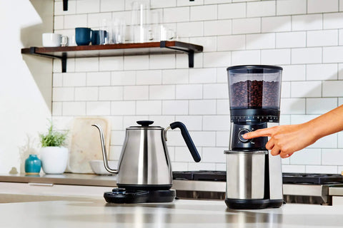 Gooseneck Electric Kettle For Pour Over Coffee And Tea With Dialed In Temperature In One Degree Increments From 104 To 212 Fahrenheit And 40 To 100 Celsius Built In Brew Timer Stainless Steel 1 Liter next to a coffee grinder on a kitchen counter