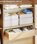 Kickass Plastic Storage Bins With Lids Full Set Decorative Boxes three sizes stacked in a wardrobe for clothing and accessories organization.