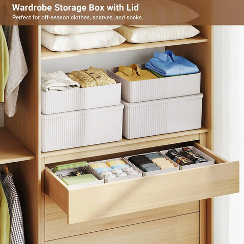 Kickass Plastic Storage Bins With Lids Full Set Decorative Boxes three sizes stacked in a wardrobe for clothing and accessories organization.